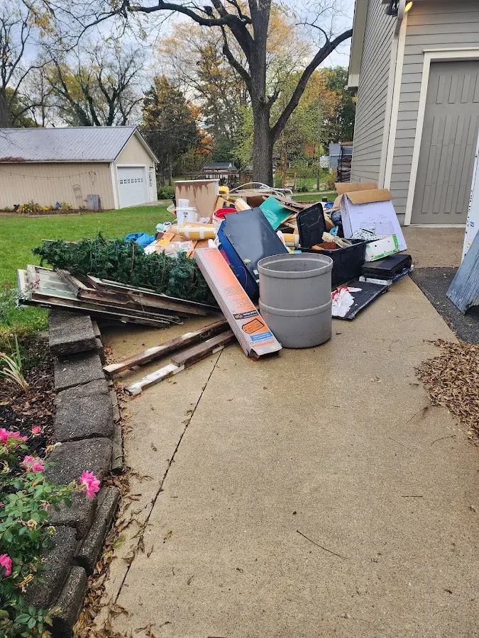 Dumpster being loaded with debris for Roofing Dumpster Rental in Waukesha